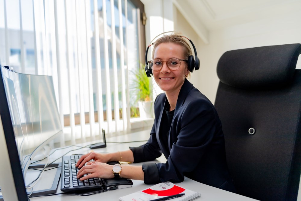 Kvinnelig rådgiver smiler mens hun snakker i telefonen